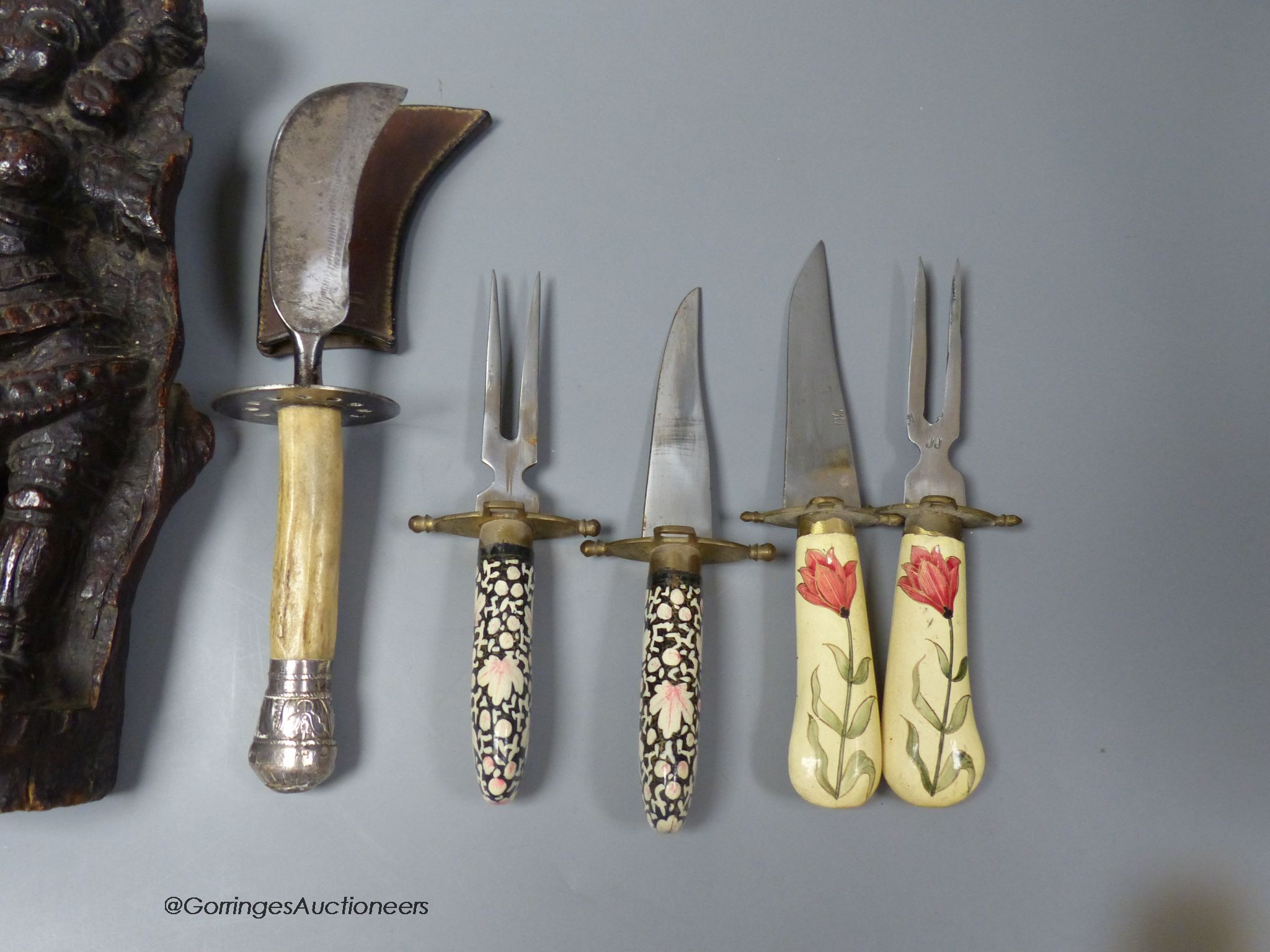 An Indian hardwood figural relief, 18th century or earlier, 28cm, a dagger and two carving knife sets